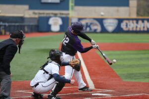 The batter swings the bat to hit the ball and baseball pitcher is behind batter